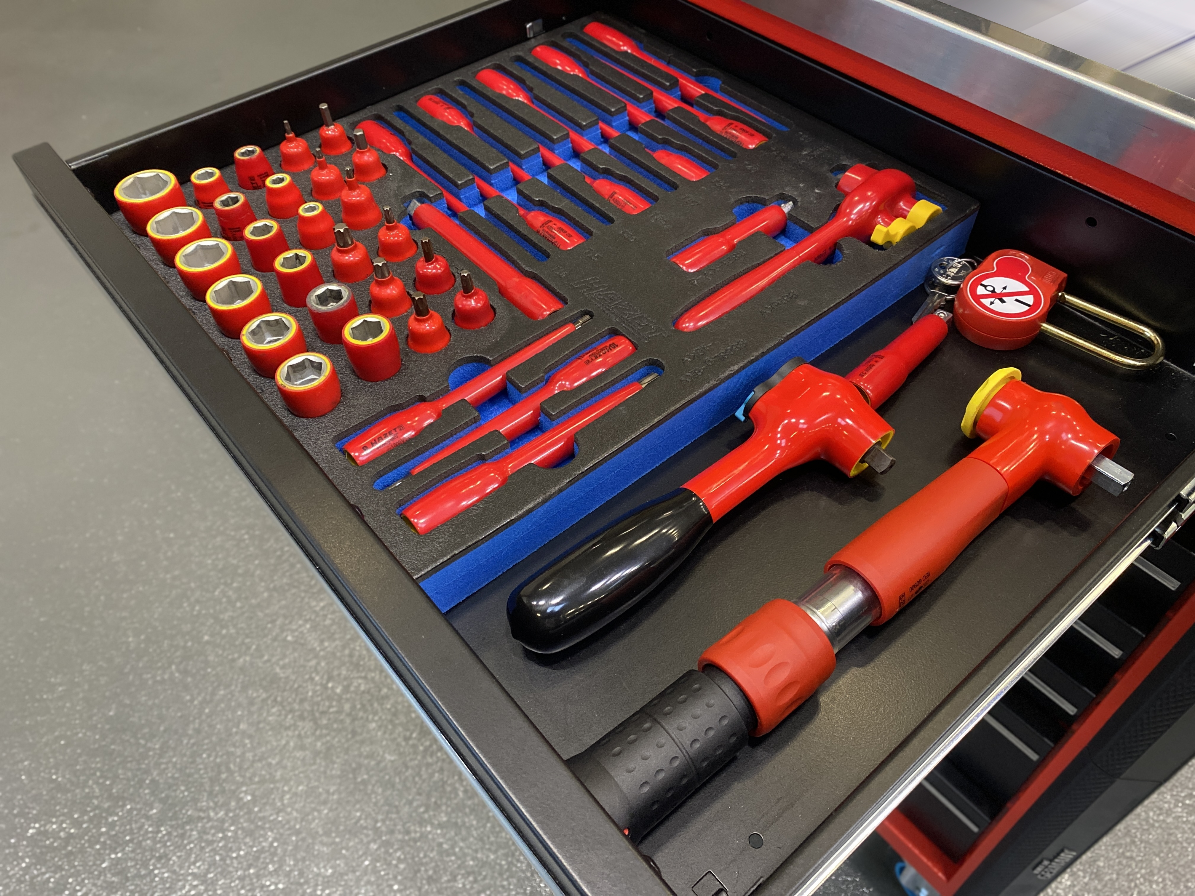 Drawer with insulated high-voltage tool set, including sockets, screwdrivers and special tools, approved and designed for working on live HV systems.